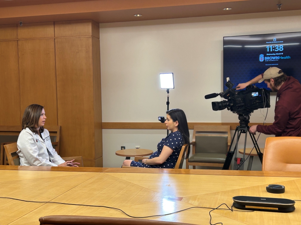 A TV station interviews a clinician at Brown University Health