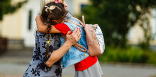 Mom hugging daughter