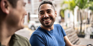 Two men laughing in bench