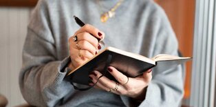 Women writing in notebook