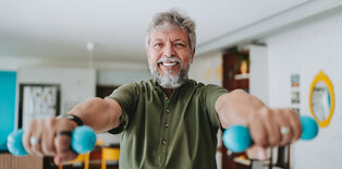 Man smiling lifting weights