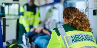Paramedics with patient in ambulance