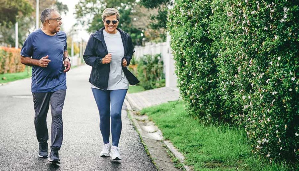 Senior couple jogging on road