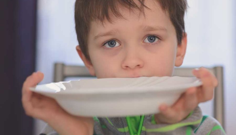 Picky eater at table with plate
