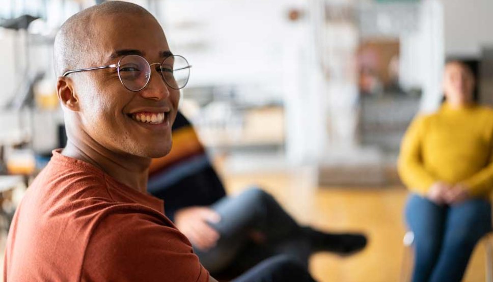 Person at group therapy session smiling