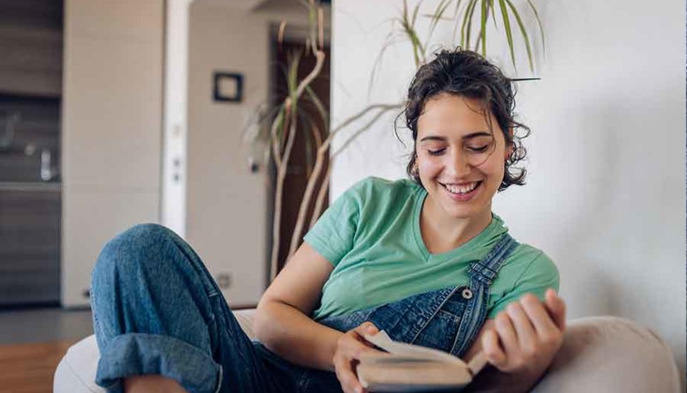 Young women reading in chair