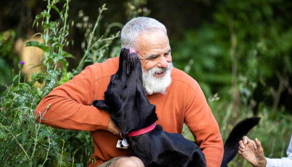 Older man with dog outside