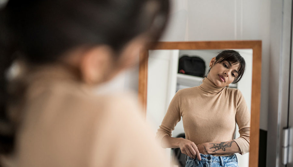 Women looking in mirror