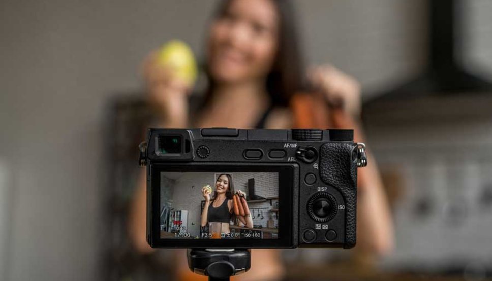 Women recording herself holding vegetables