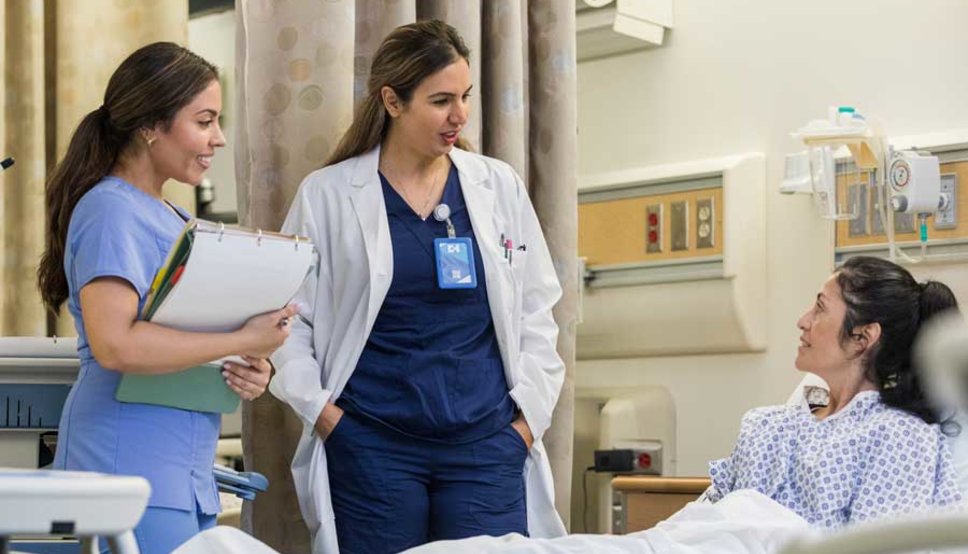 Hospitalists talking to patient