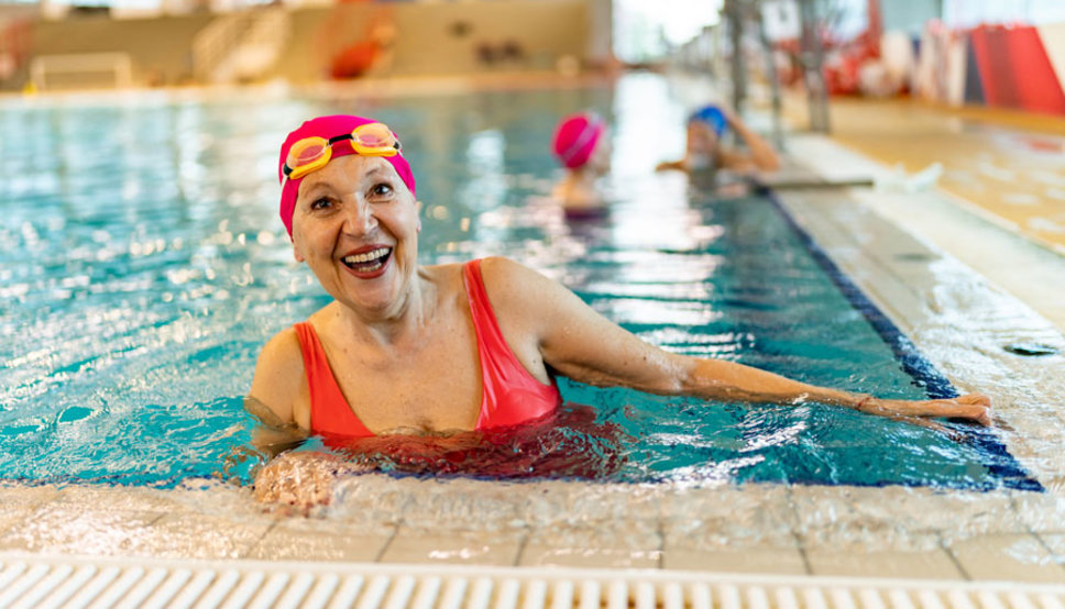 Senior women in pool smiling