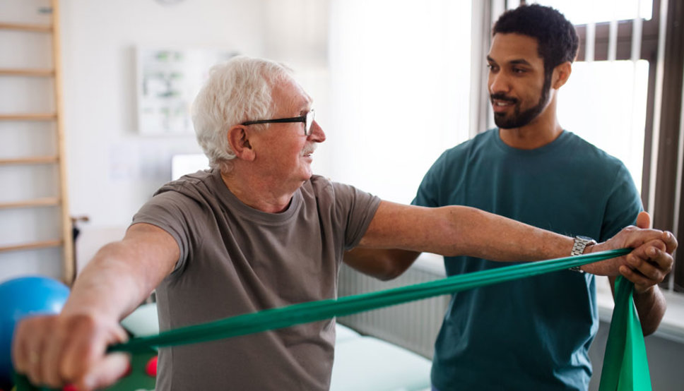 Older man receiving physical therapy