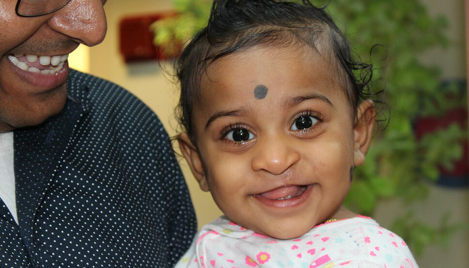 Photo of a young South Asian child smiling