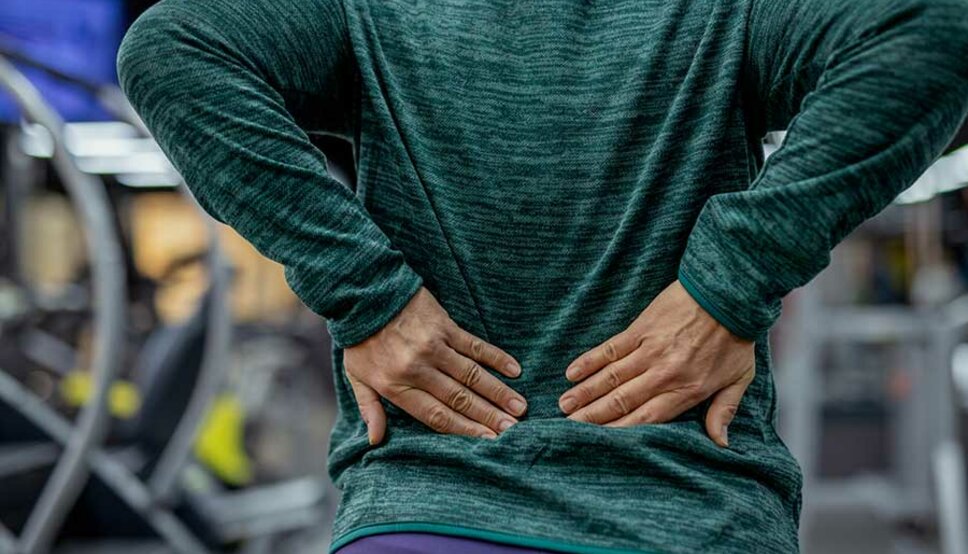 Women holding lower back from pain