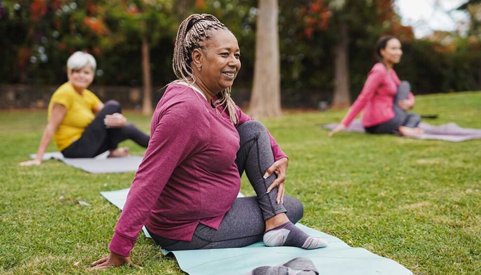 Women doing yoga in park