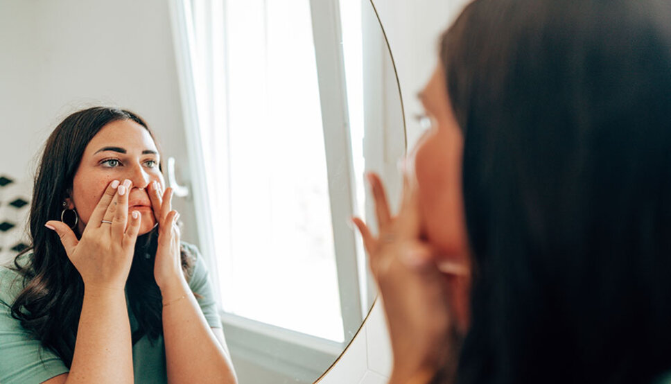 Women washing face in mirror
