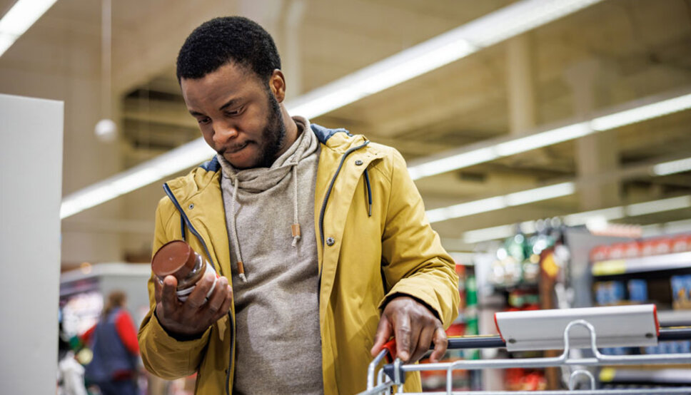 Man looking at food label grocery store