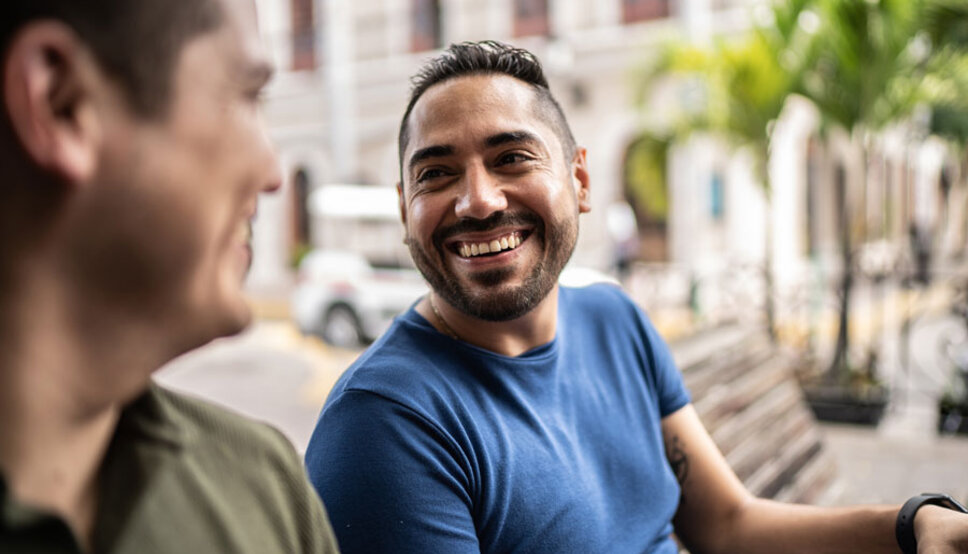Two men laughing in bench