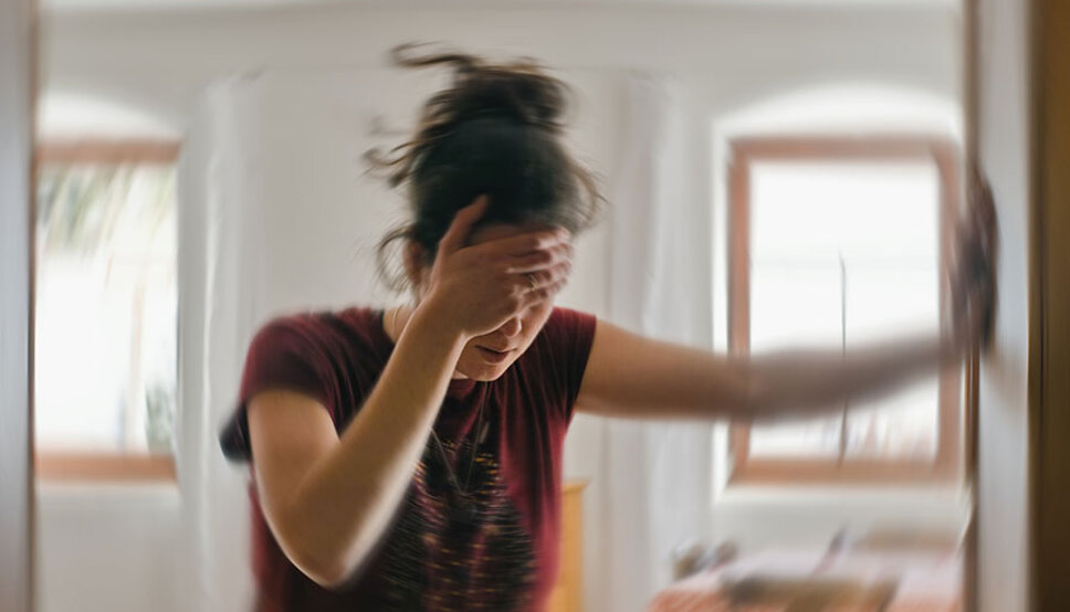Women dizzy after standing up with hand on head