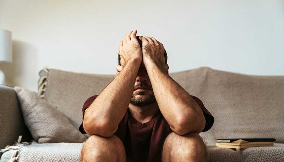 man with head in hands who is depressed