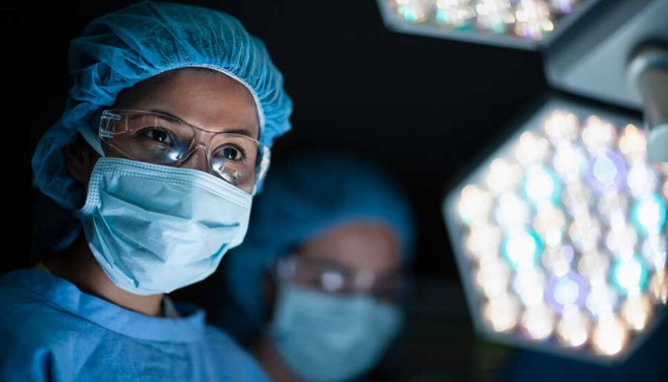 Female surgeon with medical mask