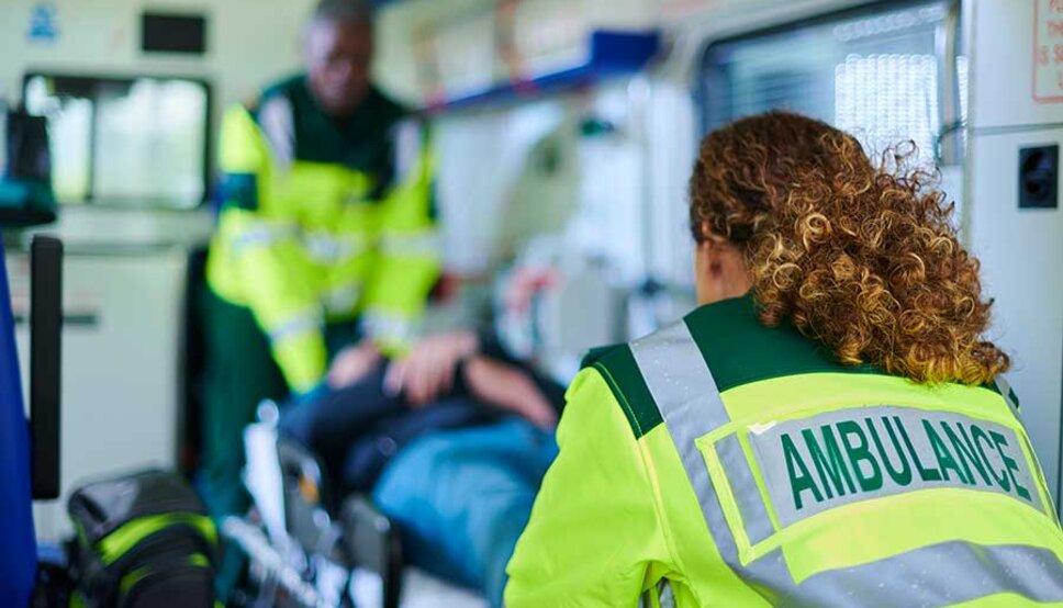 Paramedics with patient in ambulance