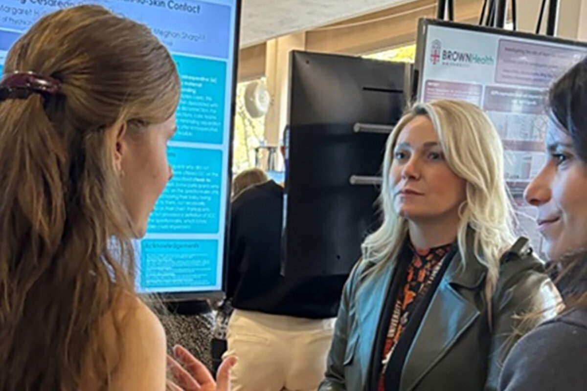 Attendee discussion in front of posters