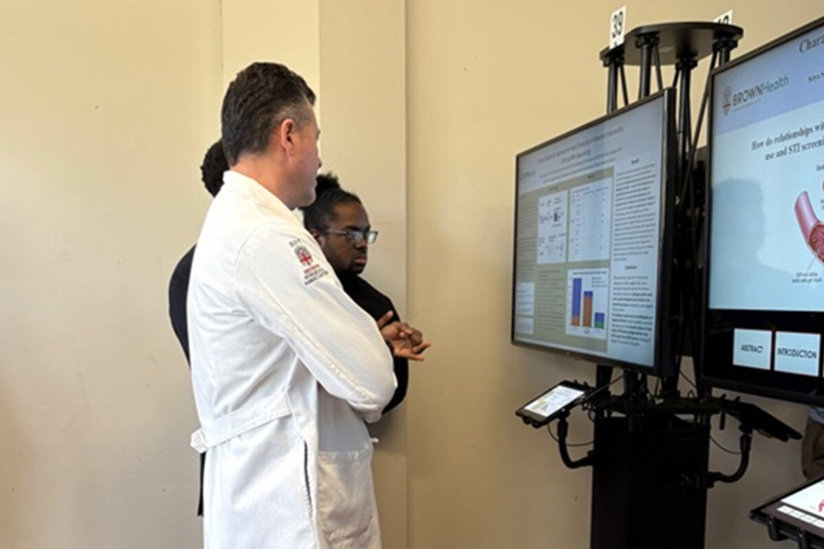 Attendees viewing digital posters