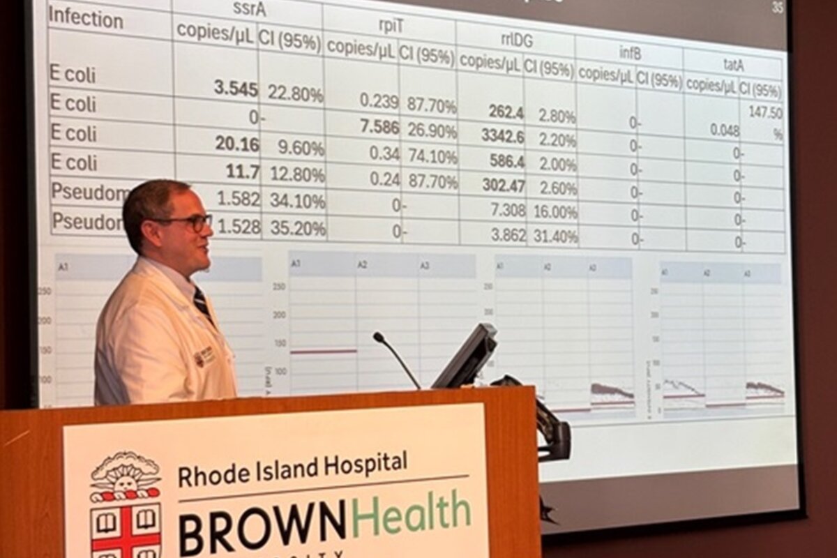 Dr. Monaghan showing slide with table