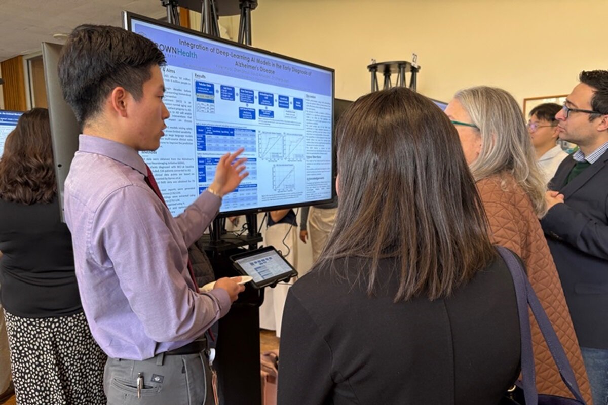 Six attendees viewing various posters