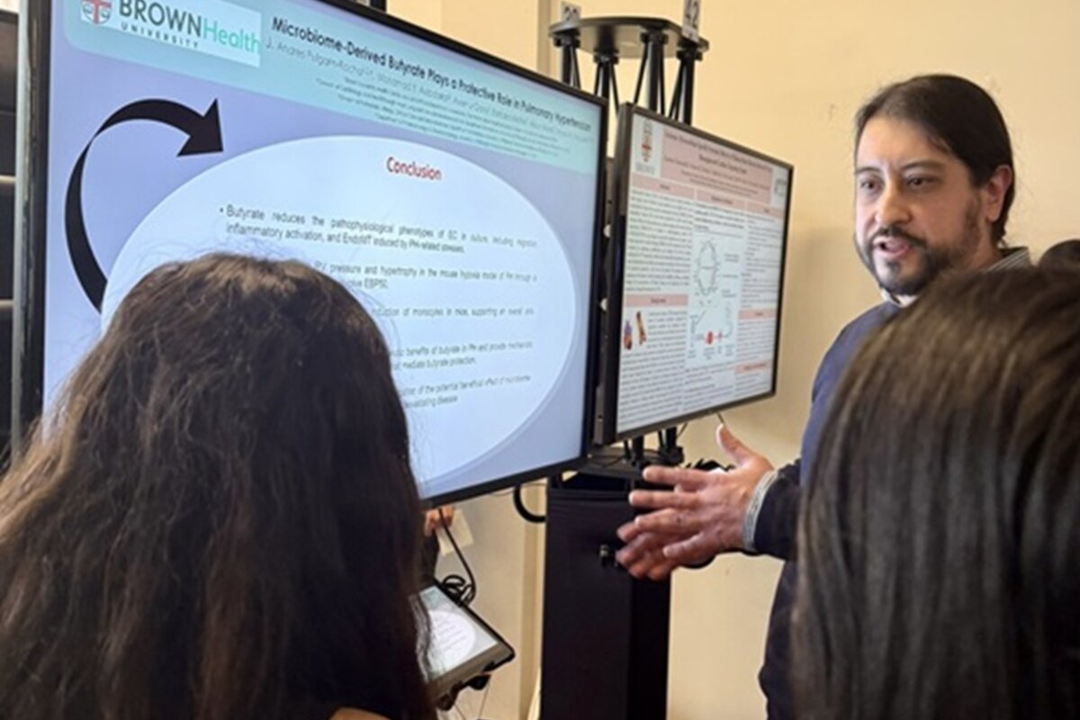 Two attendees break down poster and analyze