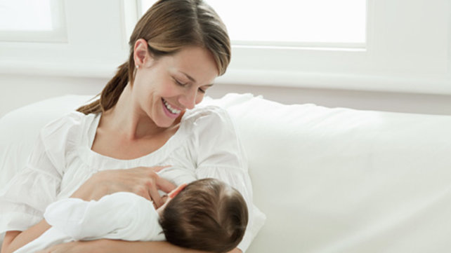 Woman nursing a baby