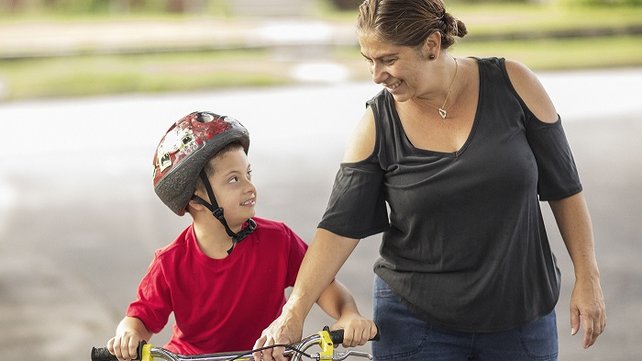 Emmanual on his bike with his mom