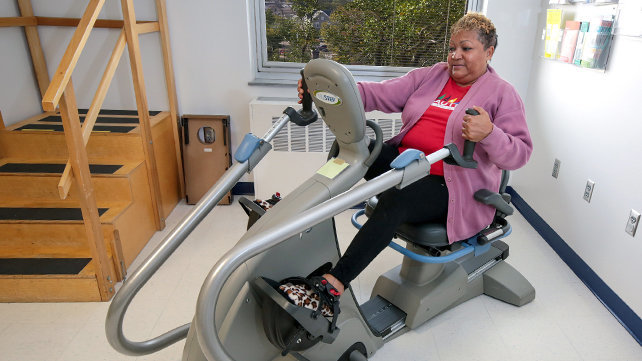 Woman on stationary bike at Inpatient Rehab at Newport Hospital