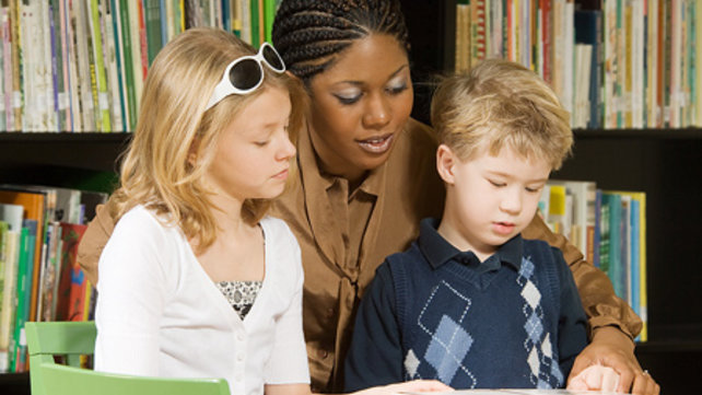 Woman reading to kids
