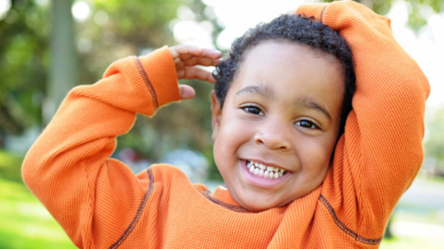 happy boy in orange shirt