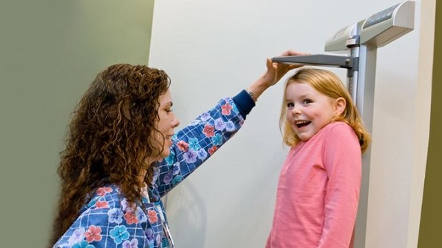 Child having her height measured