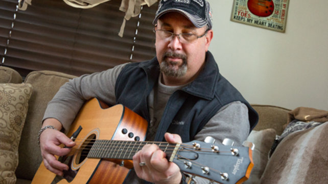 Eisner's dad playing his guitar