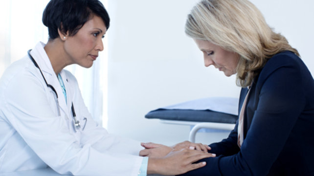 A medical person comforts another person.