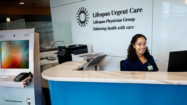 Woman sitting at Lifespan Urgent Care front desk