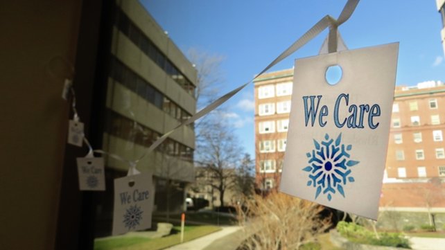 We Care sign hanging from a window