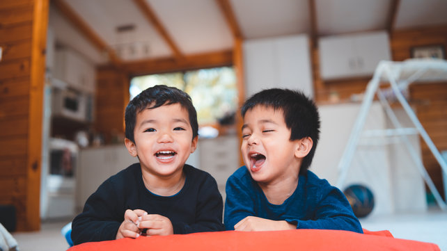 Two boys laying on floor