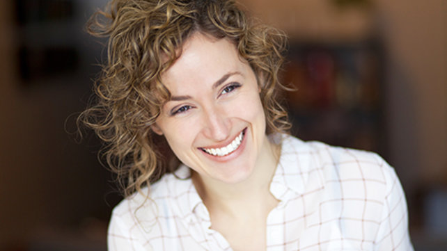 woman with curly hair smiling
