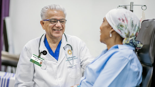 Male doctor speakng with a patient