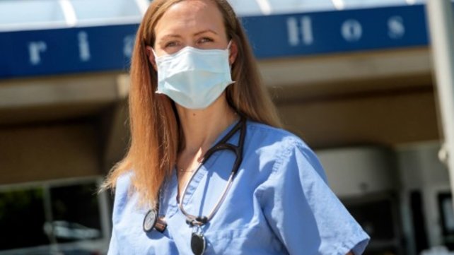 A medic stands in front of The Miriam Hospital