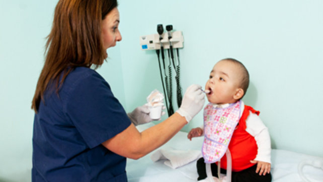 Nurse checking an infant
