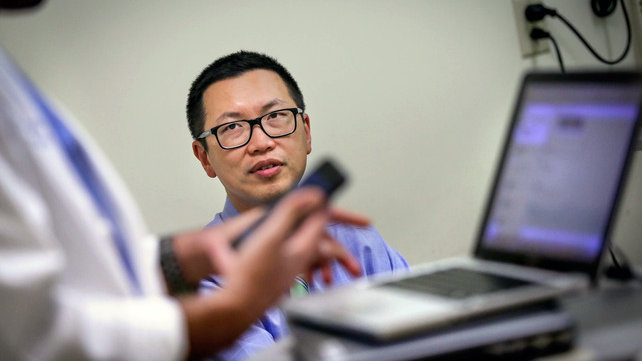Two medical personnel near a laptop.