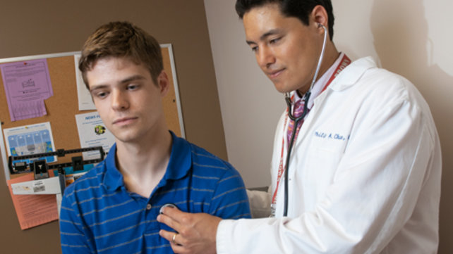 Philip Chan, MD, seeing a patient
