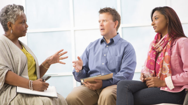 Adults speaking with a doctor