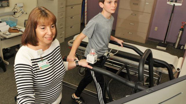 boy on treadmill with doctor